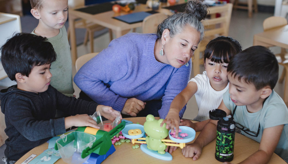 PreK educator Tara Hughes uses colorful toys to teach basic math skills to her students.