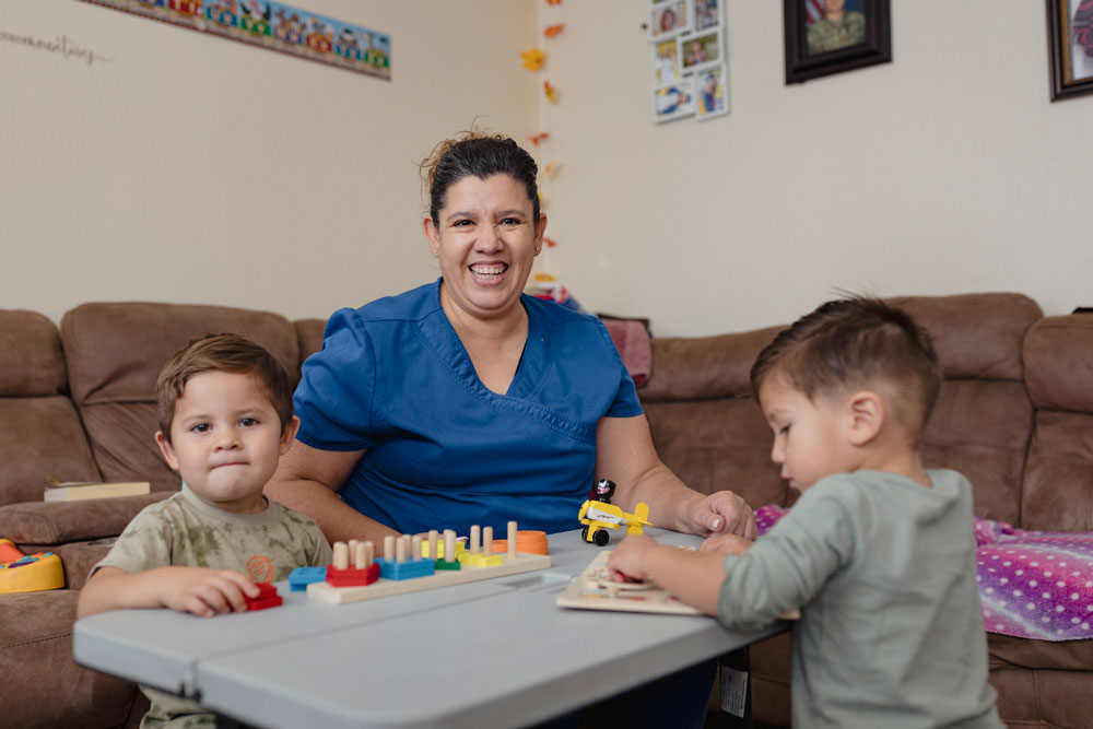 Early childhood educator Norma Gutierrez poses in her home with her students